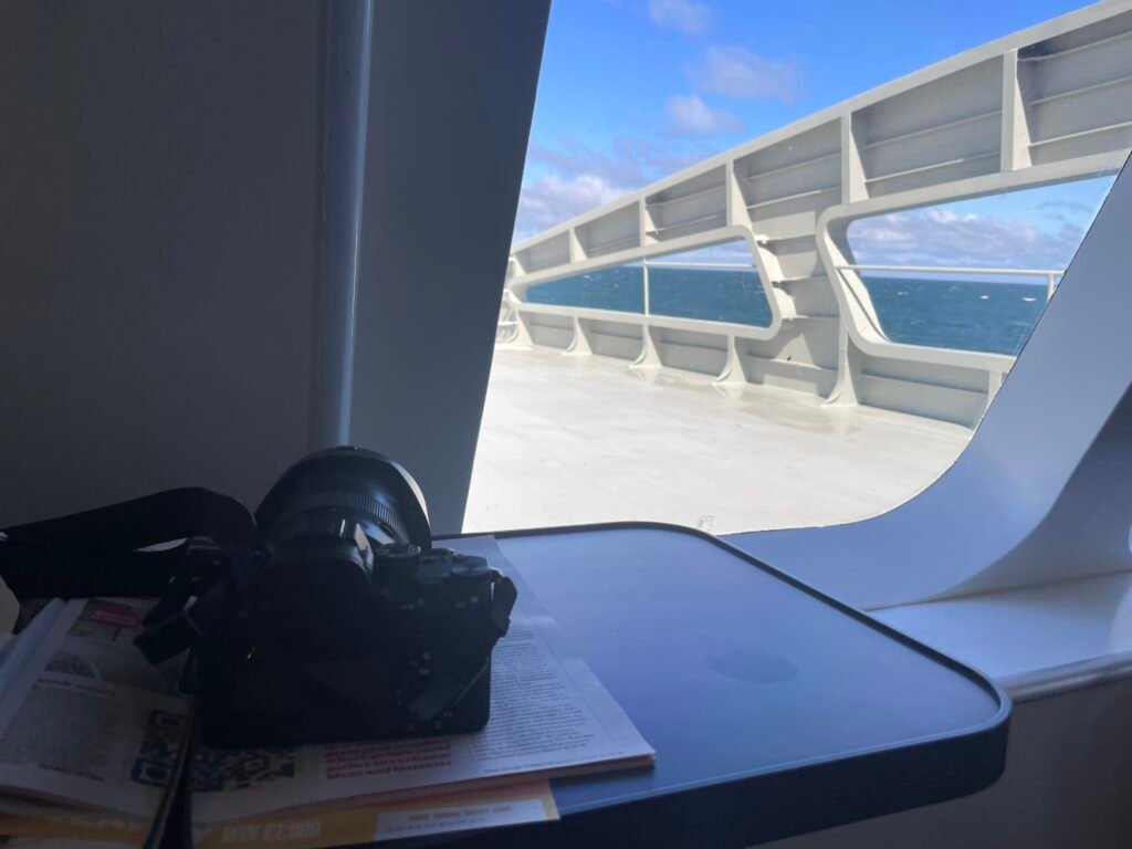 Camera on table by ferry window