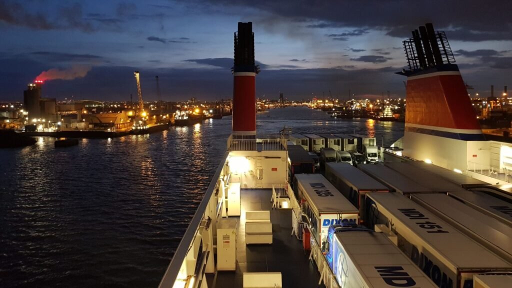 Departing ferry with trucks on rear deck at dusk