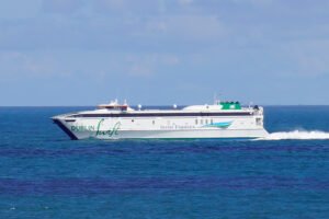 Fast white catamaran ferry sailing across the Irish Sea