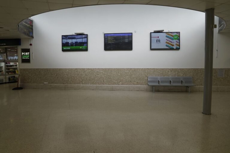 Three TV screens mounted on terminal wall