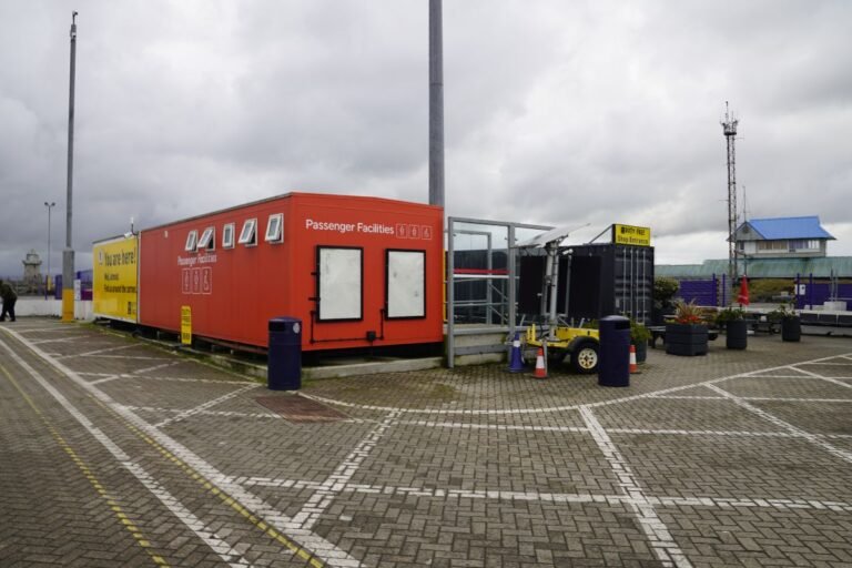 Simple container setup with restrooms and a duty-free shop in the harbour.