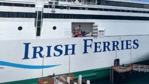 Side of ferry with large company logo